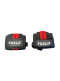 Two black wrist wraps with red straps and 'FUELD' branding on a metallic surface.