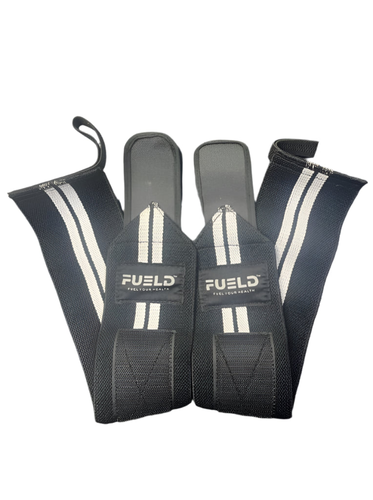 Pair of black wrist wraps with white branding on a dark background