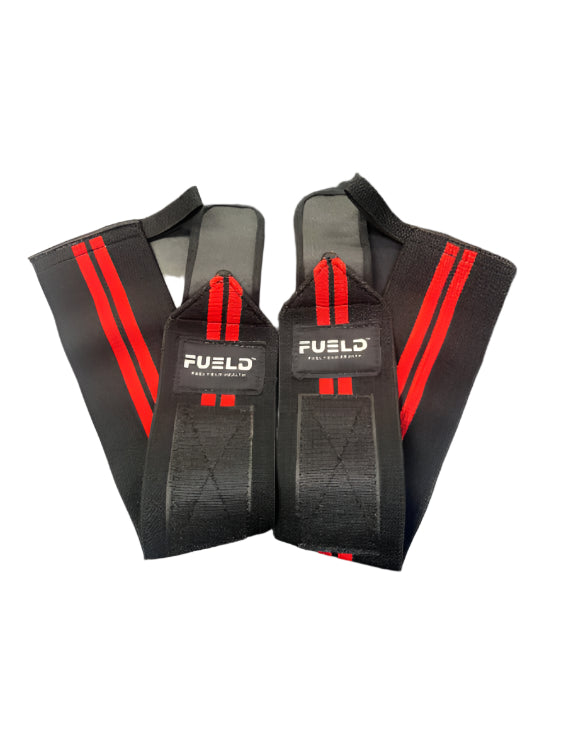 Pair of black wrist wraps with red stripes and 'Fuel' branding on a gray background