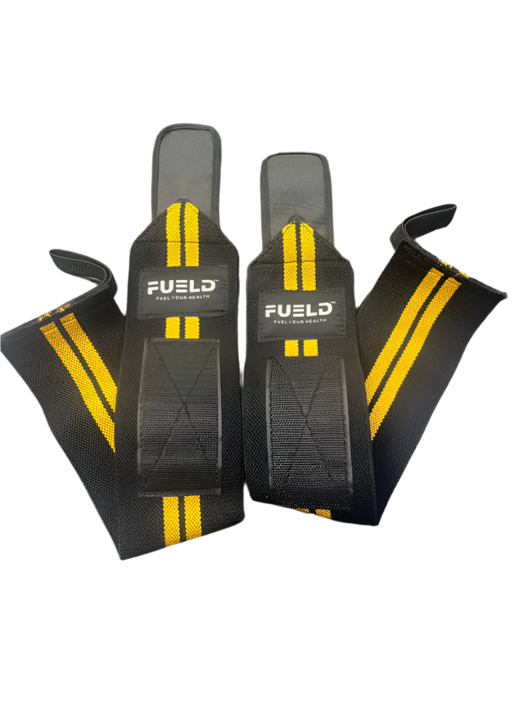 Pair of black wrist wraps with yellow stripes and 'Fuel' branding on a gray background